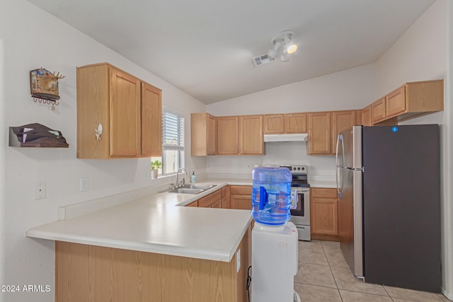 kitchen featuring sink, kitchen peninsula, light tile patterned floors, lofted ceiling, and stainless steel fridge