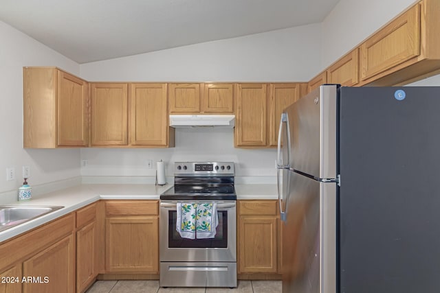 kitchen featuring lofted ceiling, sink, light tile patterned floors, and stainless steel appliances