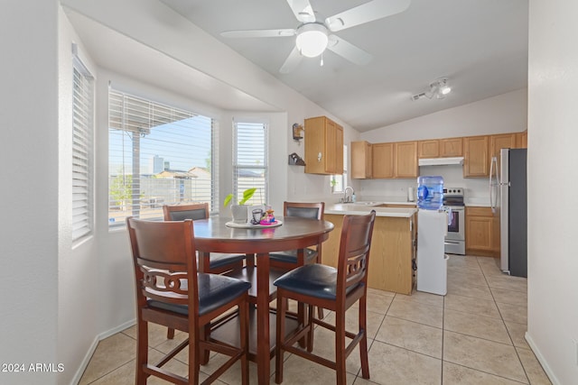 kitchen featuring sink, appliances with stainless steel finishes, ceiling fan, light tile patterned floors, and lofted ceiling