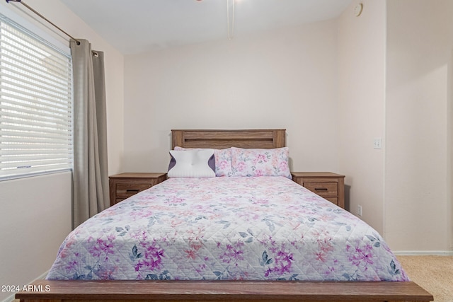 carpeted bedroom with vaulted ceiling