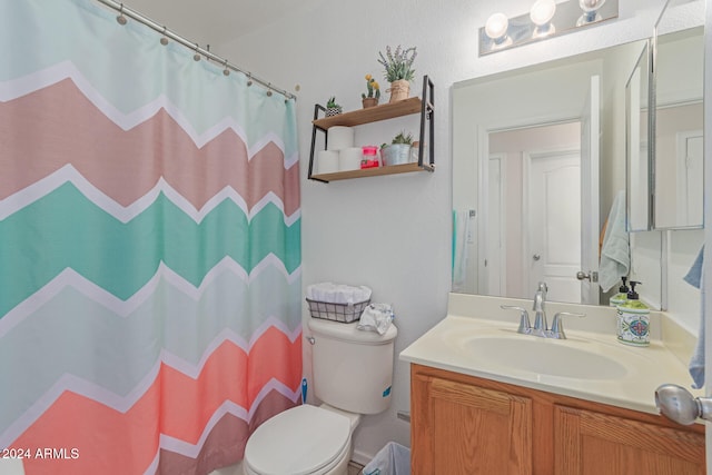 bathroom featuring toilet, vanity, and a shower with shower curtain