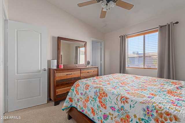 carpeted bedroom with ceiling fan and vaulted ceiling