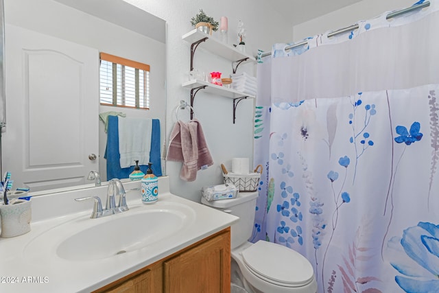 bathroom featuring curtained shower, vanity, and toilet