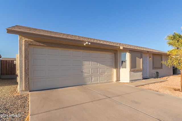 single story home with an outbuilding and a garage