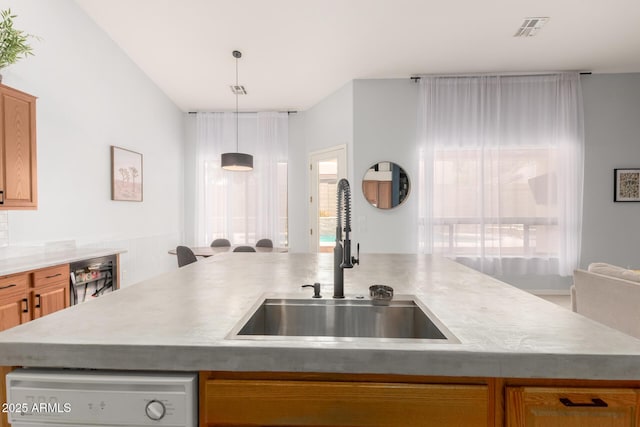 kitchen featuring a sink, pendant lighting, and light countertops