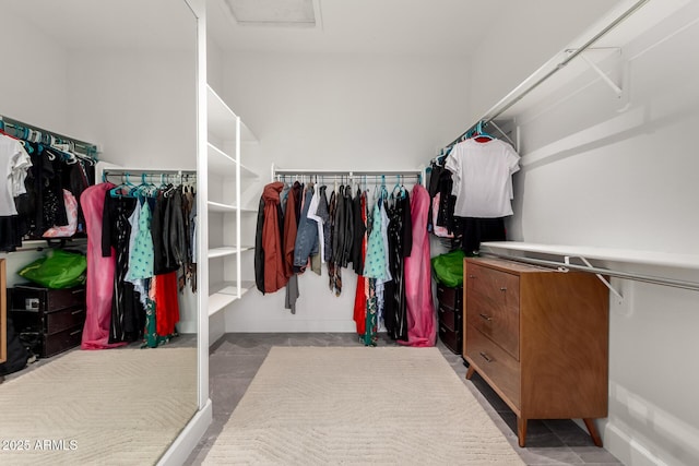spacious closet featuring attic access