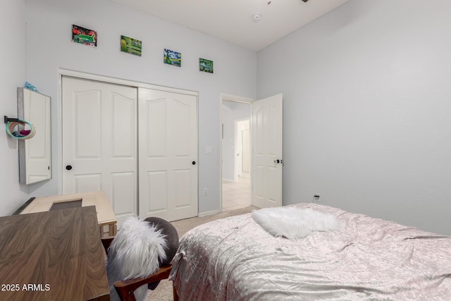 bedroom with light colored carpet and a closet