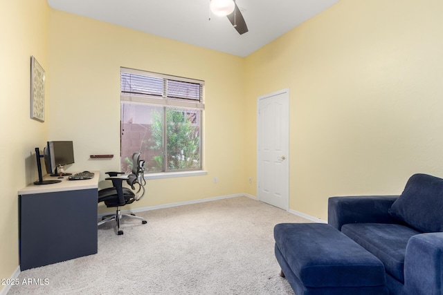 home office with carpet floors, a ceiling fan, and baseboards