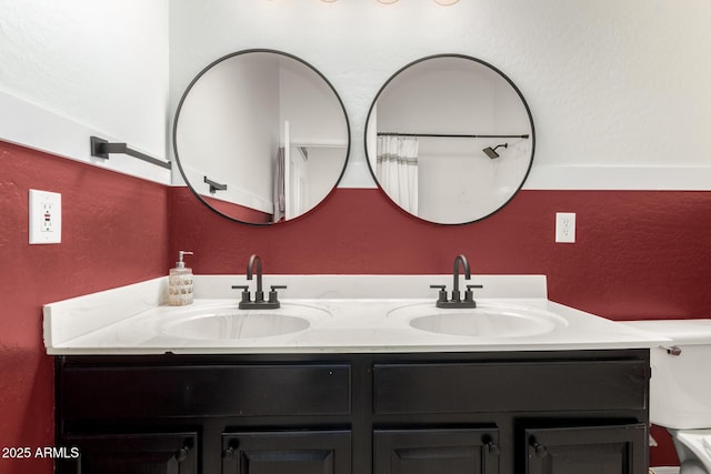 bathroom featuring double vanity and toilet