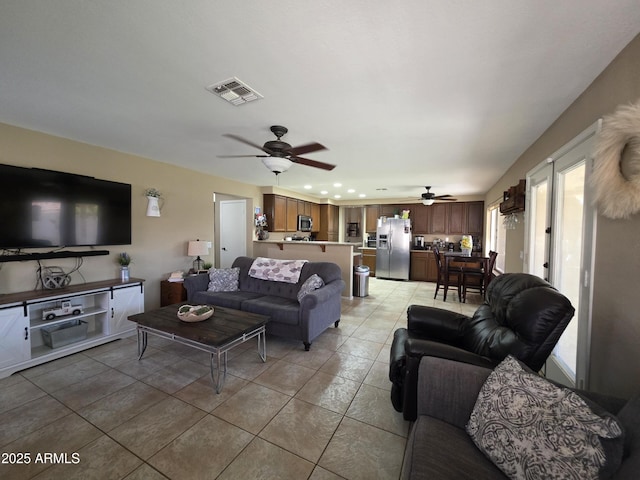 living room featuring recessed lighting, light tile patterned floors, visible vents, and a ceiling fan