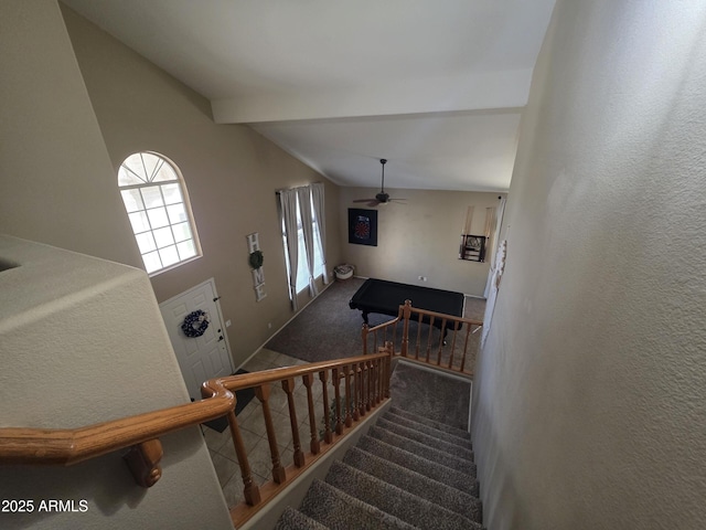 staircase featuring vaulted ceiling with beams, carpet flooring, and a ceiling fan