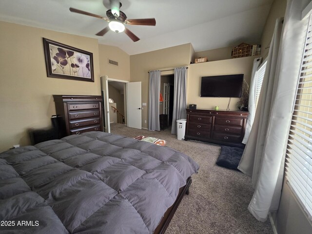 carpeted bedroom featuring visible vents, ceiling fan, and vaulted ceiling