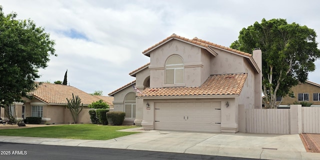mediterranean / spanish-style home featuring a front lawn, concrete driveway, stucco siding, and a tile roof