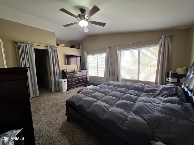 carpeted bedroom with a ceiling fan and vaulted ceiling