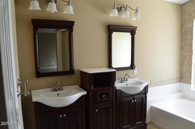 full bath featuring a sink, a bath, and two vanities