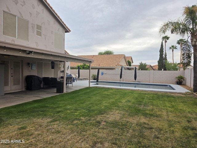 view of yard with a fenced in pool, a patio, and a fenced backyard