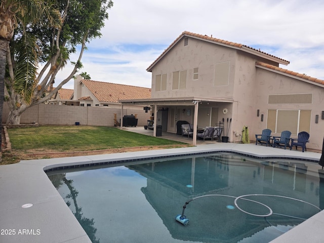 view of swimming pool with a patio area, a fenced in pool, fence, and a lawn