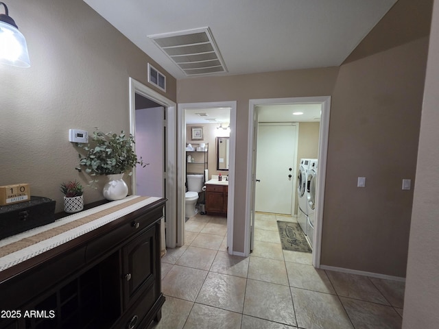 full bathroom with tile patterned floors, vanity, washing machine and dryer, and visible vents
