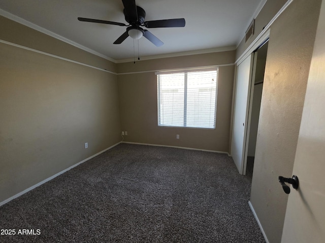 unfurnished bedroom featuring crown molding, carpet floors, baseboards, and visible vents