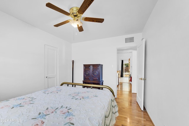 bedroom with ceiling fan and light wood-type flooring