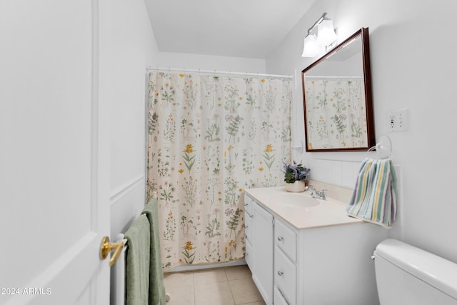 bathroom with toilet, vanity, tile patterned flooring, and a shower with curtain