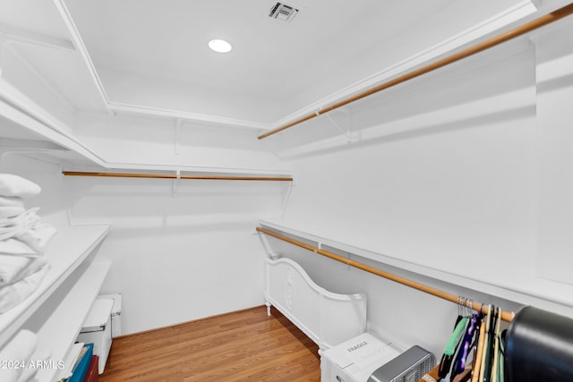 spacious closet with light hardwood / wood-style flooring