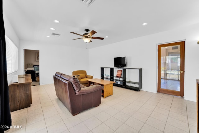 living room featuring ceiling fan, light tile patterned floors, and a healthy amount of sunlight