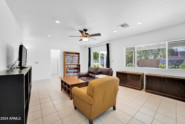 living room with ceiling fan and light tile patterned floors