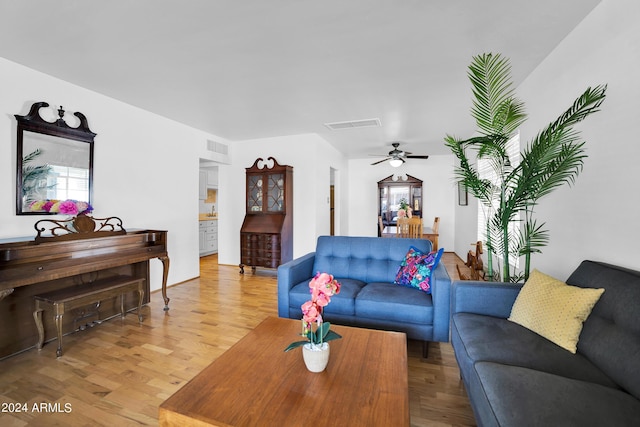 living room featuring hardwood / wood-style floors and ceiling fan