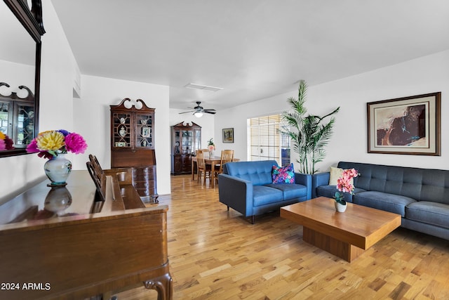 living room with ceiling fan and light wood-type flooring