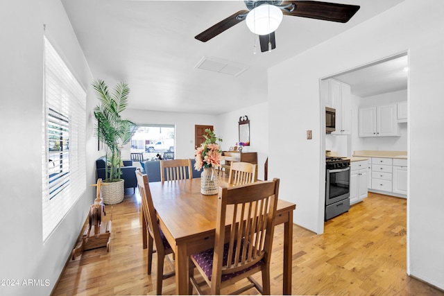 dining space featuring light wood-type flooring and ceiling fan