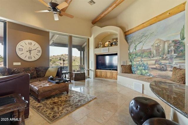 living area with ceiling fan, visible vents, and beam ceiling