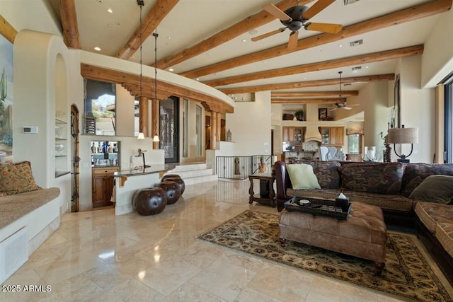 living area with visible vents, arched walkways, ceiling fan, marble finish floor, and beam ceiling