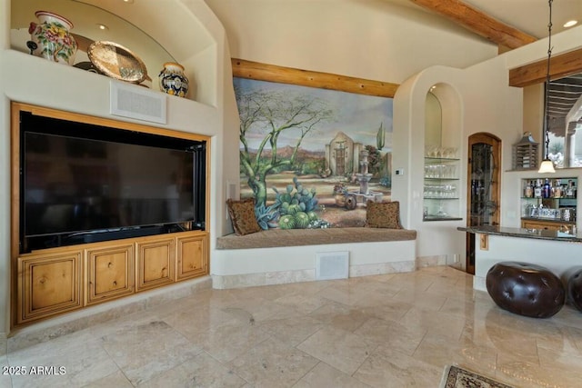 living room featuring visible vents, a dry bar, and beam ceiling