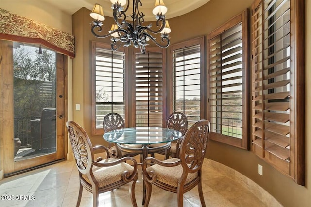 dining area with a notable chandelier and light tile patterned floors