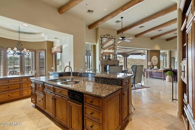 kitchen with hanging light fixtures, brown cabinets, a sink, and visible vents