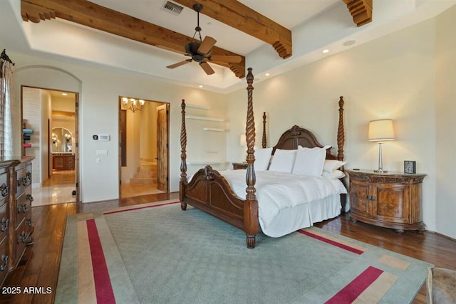 bedroom featuring arched walkways, recessed lighting, visible vents, hardwood / wood-style floors, and beamed ceiling