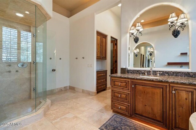 full bath with a shower stall, baseboards, and vanity