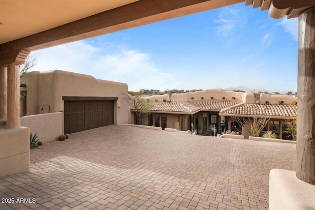 exterior space featuring a garage and stucco siding