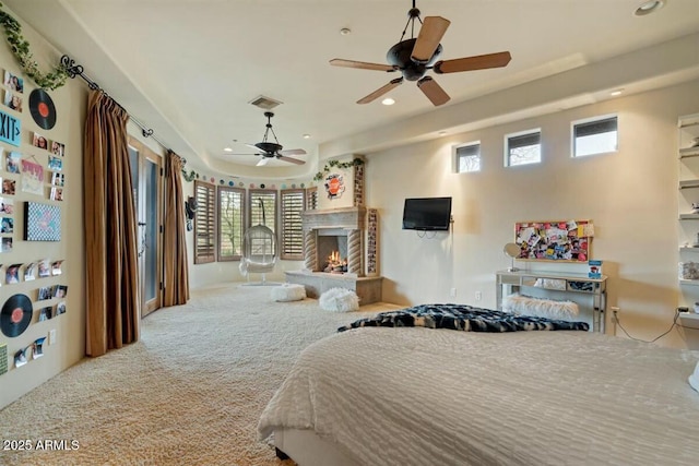 bedroom featuring a lit fireplace, visible vents, carpet flooring, and recessed lighting