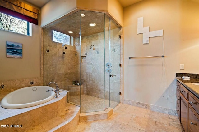 bathroom featuring a bath, a stall shower, vanity, and baseboards