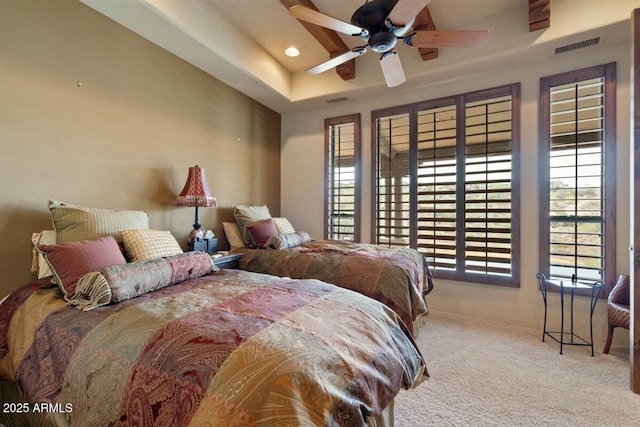 bedroom with carpet floors, a tray ceiling, visible vents, and recessed lighting