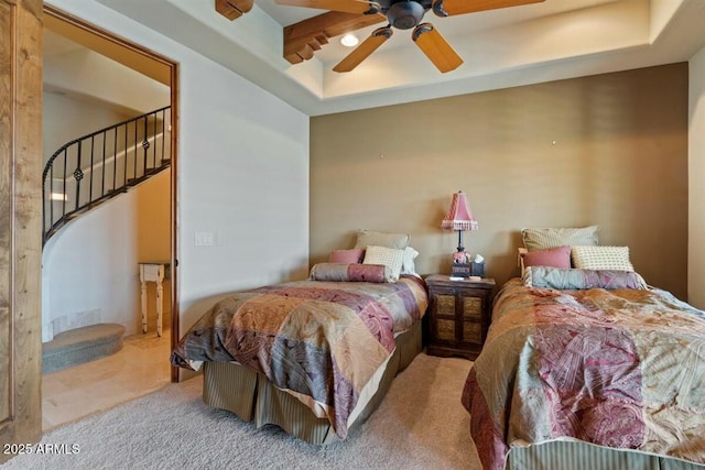 bedroom featuring a ceiling fan and a tray ceiling