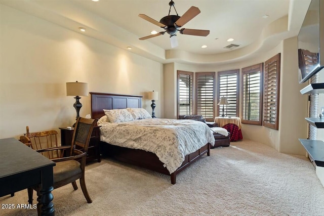 bedroom featuring light carpet, visible vents, a ceiling fan, a tray ceiling, and recessed lighting