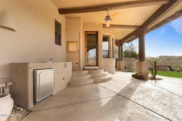 view of patio featuring ceiling fan