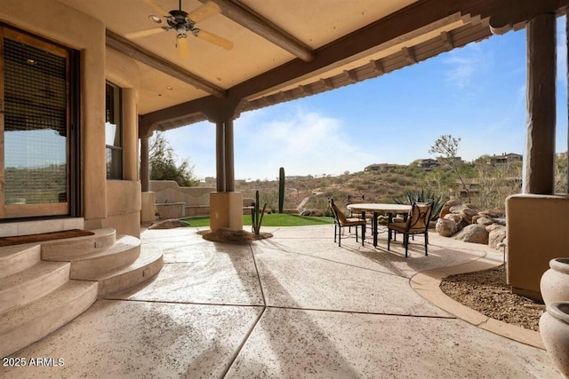 view of patio with a ceiling fan, entry steps, outdoor dining area, and fence