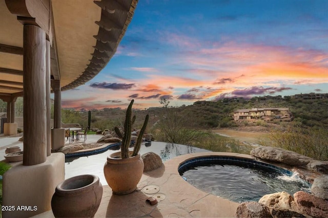 view of swimming pool featuring an in ground hot tub and a patio area