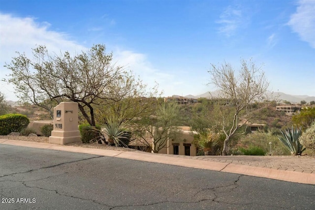 southwest-style home featuring a mountain view and stucco siding