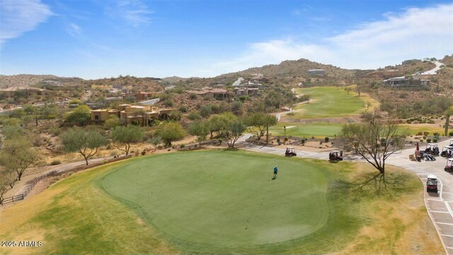 view of community featuring view of golf course and a mountain view