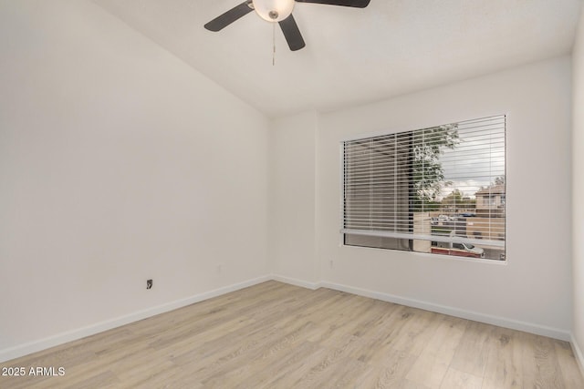spare room with wood finished floors, ceiling fan, and baseboards